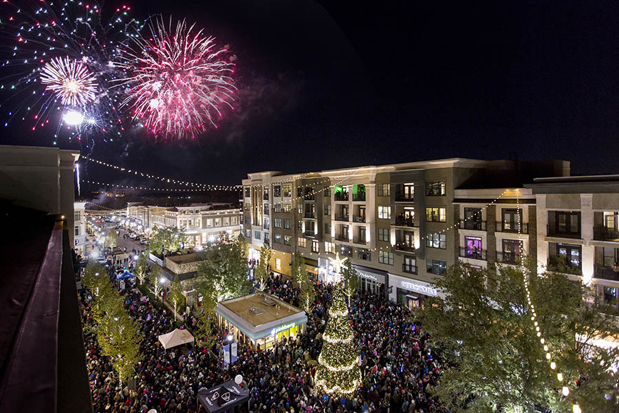 Crowds pack the roads and sidewalks of Avalon during its Christmas tree lighting event. The mixed-use development opened in October 2014 and quickly attracted national attention for its mix of retail, resturants, high-end apartments, and single-family homes. A second phase of the development will open in 2017. (Photo: North American Properties)