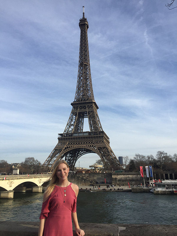 Claire Anderson in front of the Eiffel Tower in Paris.