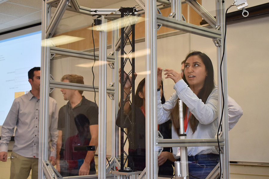 Margaret Ortiz, right, and Ronak Lakhani prepare their structural tower for testing at the ASCE Carolinas Conference. Their structure had the competition’s best load efficiency and placed second overall. (Photo Courtesy: David Scott)