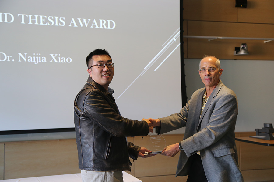Naijia Xiao receives his award from Ted Russell