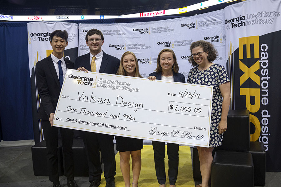 Vakaa Design — a team comprising, left to right, Justin Liu, Chris Folsom, Kailee Unangst and Hannah Davis — accepts the first-place check for civil and environmental engineering at the spring 2019 Capstone Design Expo alongside Associate Professor Kari Watkins. The team had to design the alignment of new express lanes along Interstate 285 in northwest Atlanta, including the structural elements to supported the elevated lanes. (Photo: Amelia Neumeister)