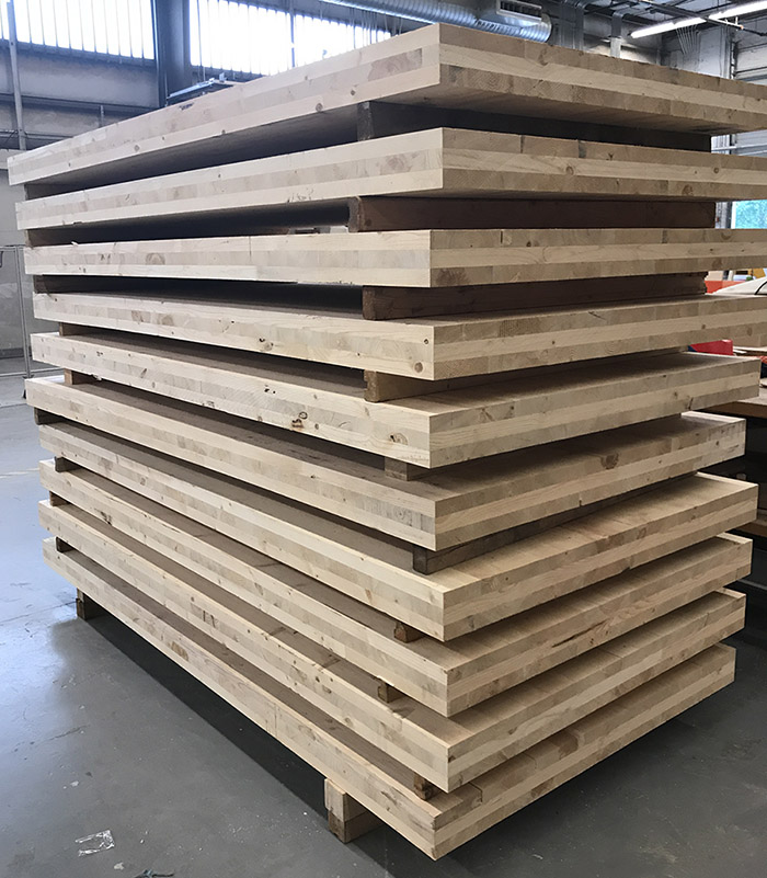 A stack of cross-laminated timber panels illustrates how the product is made by created three, five, or seven layers of lumber oriented at right angles to one another and then glued together. (Image Courtesy: Lauren Stewart)