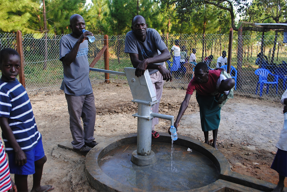 Residents of Oloo, Uganda, drink water from the well and hand pump Georgia Tech students installed in December 2014. Tech's Engineers Without Borders chapter has been working with the community for years on the project, and a group of students will travel to the village during Spring Break to continue expanding the system. Led by civil engineering major Ashley Maynard, they plan to install a new water tap along a pipeline the group built last year. (Photo Courtesy: Engineers Without Borders Georgia Tech)