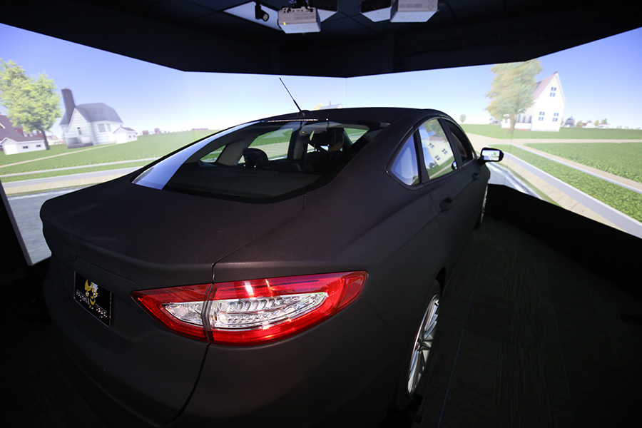 The new driving simulator lab includes this full-size Ford Fusion and two smaller desktop simulators that can interact in the simulated environment. Frederick R. Dickerson Chair Srinivas Peeta and his team will present all kinds of scenarios to test drivers and monitor their reactions in an effort to unlock new insights into how people behave behind the wheel — and eventually create a better transportation network for everyone. (Photo: Candler Hobbs)