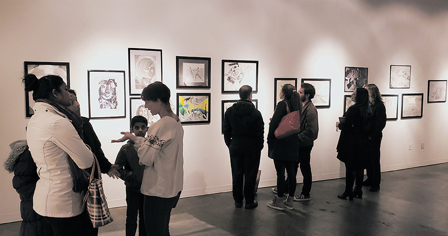 Visitors consider the artwork created by students in Francesco Fedele's Visual Arts and Geometry course at the Kai Lin Gallery Dec. 11. The drawings hung for one night at the gallery to celebrate the students' work in the class, which connected advanced geometry with art through the lenses of Einstein and Picasso.