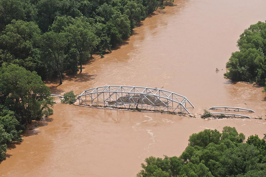 Oklahoma's Washita River washes over the Highway 377 bridge in June 2015. Sturm and Hong studied the erosion around a bridge's abutments in this kind of flood situation as well as in situations where the bridge opening is submerged but water does not overtop the bridge. (Photo: Army Corps of Engineers)