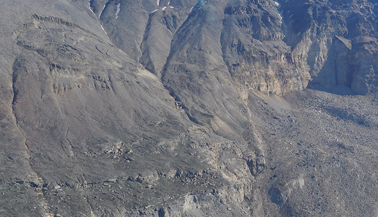 A closer look at the two landslides in Greenland. On the right, the scar left on the hillside from a landslide that dropped a kilometer into the water below. On the left is a still-active slide starting to separate from the hillside. (Photo: Hermann Fritz)