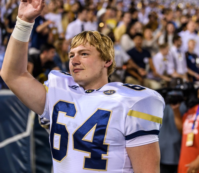 Civil engineering master's student Cheyenne Hunt waves during one of Georgia Tech's football games this year. Hunt is a walk-on offensive tackle finishing his final year on the team. (Photo: Danny Karnik/Georgia Tech Athletics)