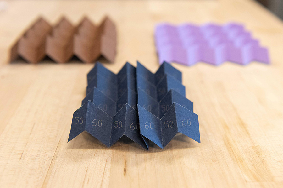 Samples of a new type of origami that can morph from one pattern into a different one, or even a hybrid of two patterns, instantly altering many of its structural characteristics. Glaucio Paulino and his colleagues described this new “morph” origami in the journal Physical Review Letters in April 2019. (Credit: Allison Carter)