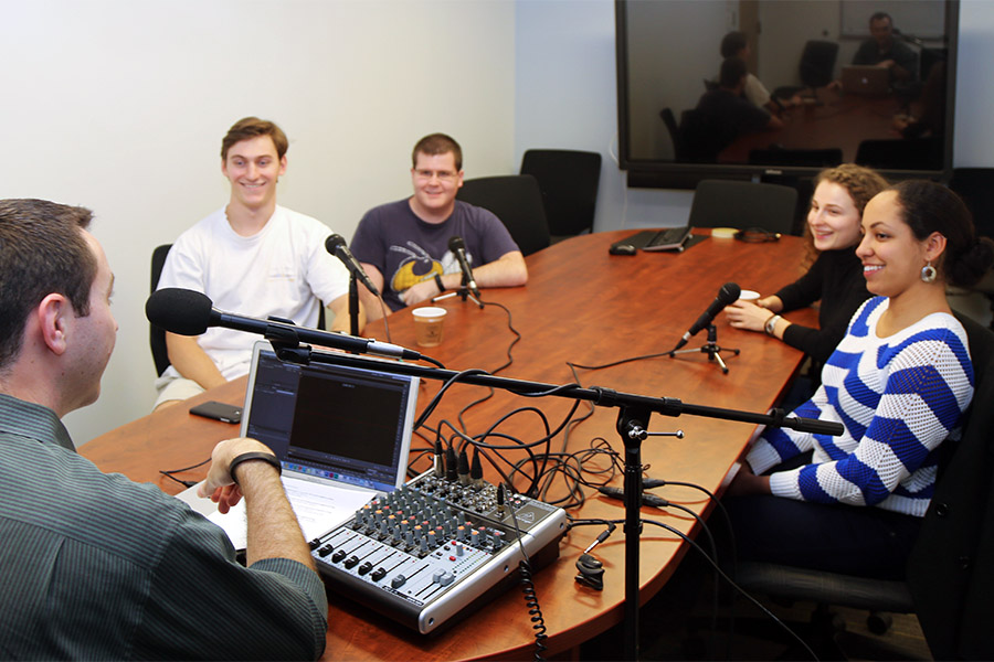 Students prepare for a recording as part of the School of Civil and Environmental Engineering's new podcast, Field Notes. The first episode focuses on giving prospective students insight into studying at the School and pursuing careers in civil and environmental engineering. From left, host Joshua Stewart, senior Robert Barclift, senior Daniel Huckaby, junior Diana Chumak, and sophomore Monica Martelly talk about classes, internships, living in Atlanta, and making it through the first year of college. (Photo: Jess Hunt-Ralston)