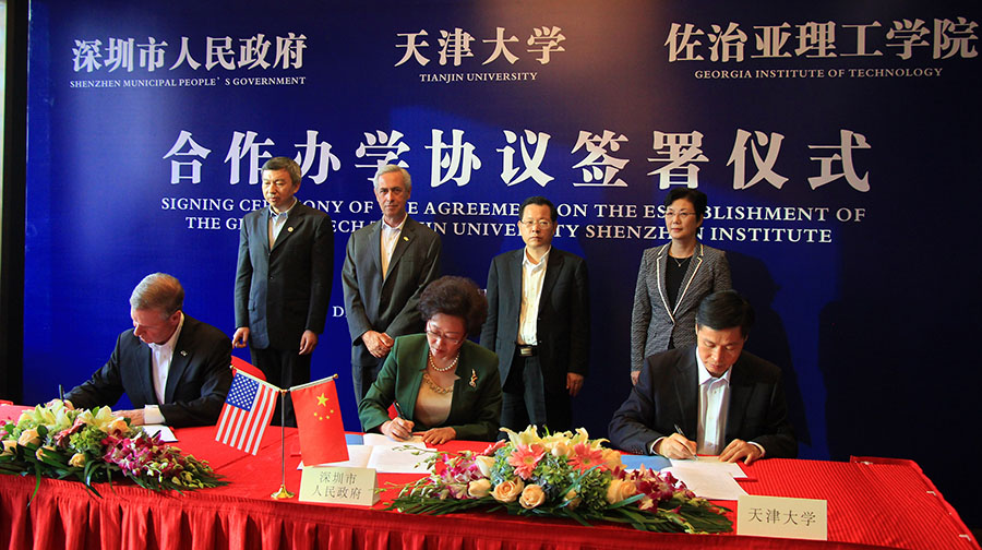 Georgia Tech President G.P. “Bud” Peterson, seated left, signed an agreement in a ceremony in Shenzhen, China, Dec. 2 to create a new collaboration with the City of Shenzhen and Tianjin University. Co-signers with Peterson are Vice Mayor Yihuan Wu of Shenzhen Municipal People's Government, center, and Tianjin University President Denghua Zhong, right.