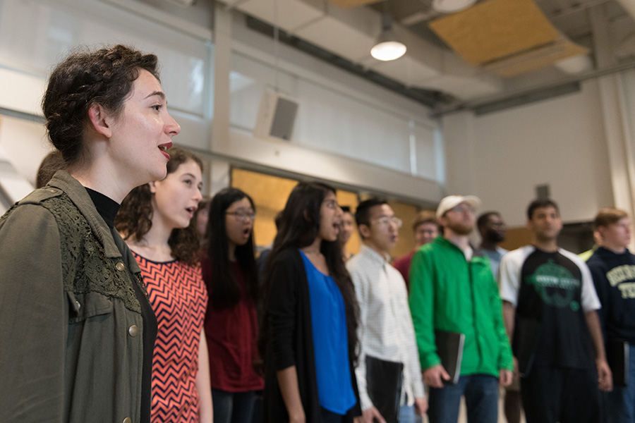 Giuliana Stovall, left, sings with the Georgia Tech Chamber Choir. In addition to founding Yellow Jacket Roller Derby, she sings in the choir and an a cappella group called Nothin' But Treble, and she's a resident assistant. All of those activities build community for Stovall, and are part of the reason she estimates she knows about one of every 64 people on the Georgia Tech campus. (Photo: Allison Carter)