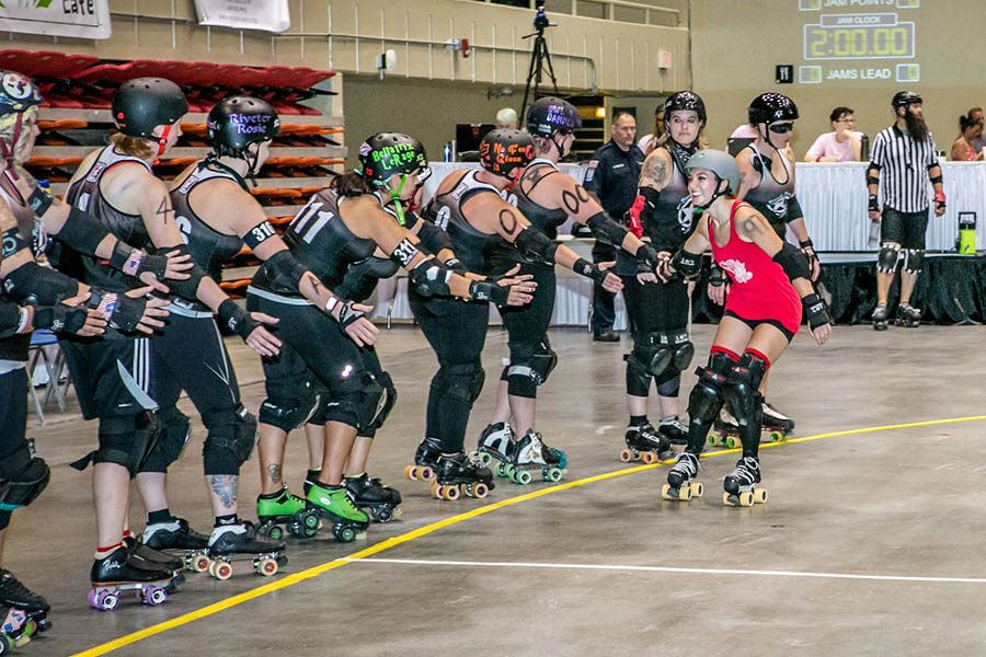 Giuliana Stovall high-fives other players after a roller derby bout with the Savannah Derby Devils, her hometown team. Stovall traveled with the team one summer and has played with teams from England to Texas. This summer, she hopes to connect with a team in the Boston area, where she'll be working at an internship. (Photo: Casey Jones Photography)