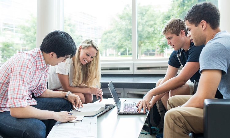 Students gathered around a table working