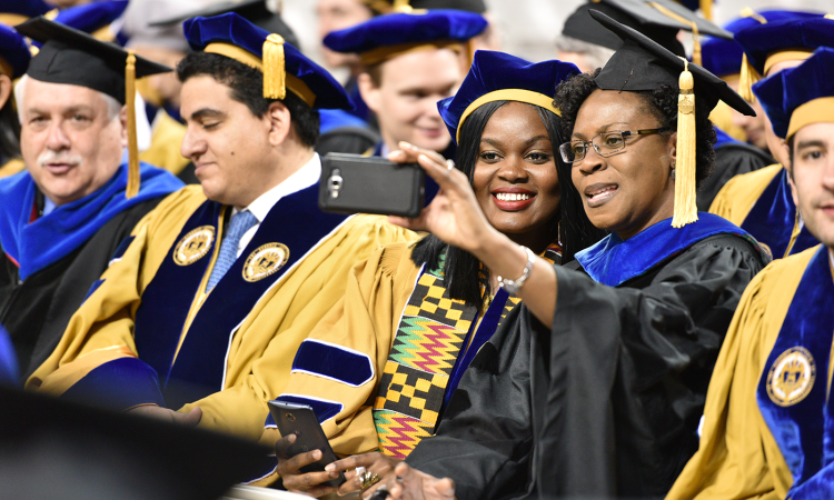Two women taking a selfie at graduate student commencement
