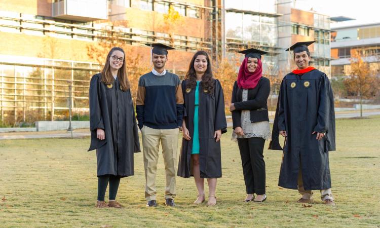 Diverse group of students standing on Tech Green