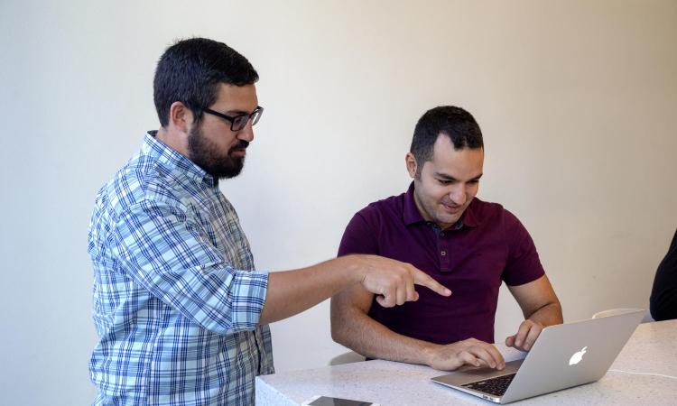 Men working on a laptop