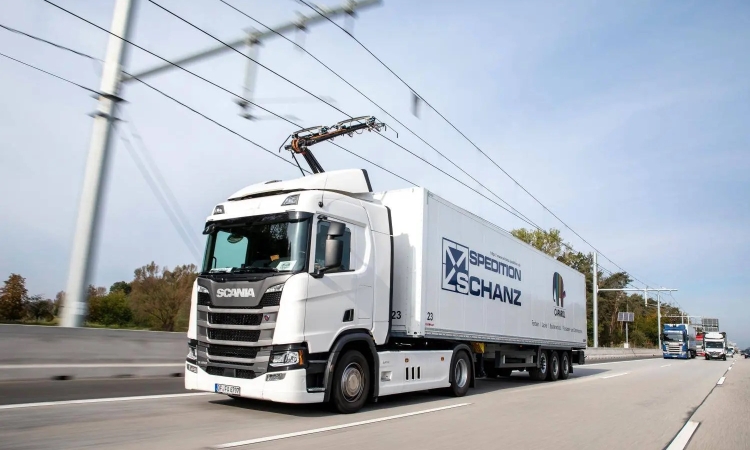an electric truck running on an overhead cable line