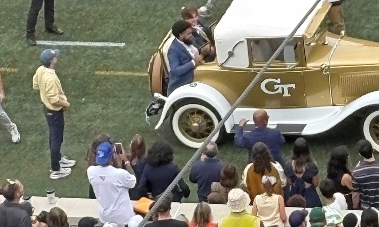 Environmental engineering fourth-year student Harrison Baro rides in the rumble seat of the Ramblin’ Reck with fellow honoree Caleb Buchanan 