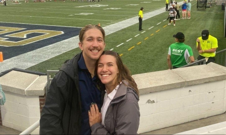 Portrait of Michael Bauby with his girlfriend at a Georgia Tech football game