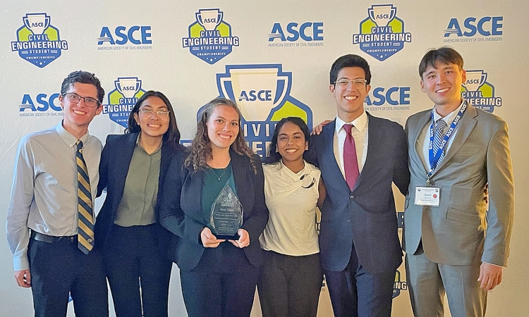 Group of three male and three female students standing in front of an ASCE backdrop holding their first place award