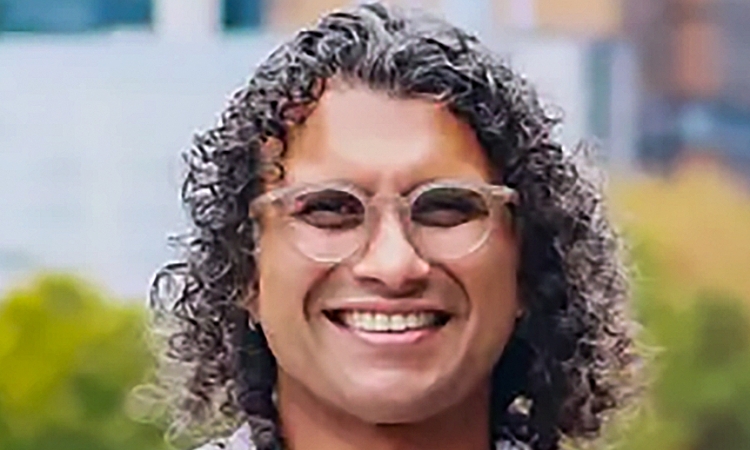 Photo of Ameet Pinto smiling and wearing a floral patterned shirt