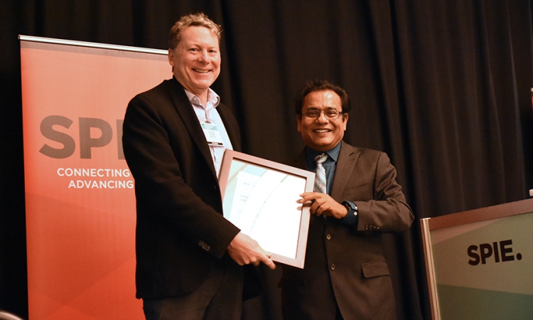 Professor and Associate Dean Laurence Jacobs, left, accepts a lifetime achievement award in nondestructive evaluation from Tribikram Kundu at the SPIE Smart Structures and Nondestructive Evaluation Symposium in early March. (Photo Courtesy: Laurence Jacobs and SPIE)