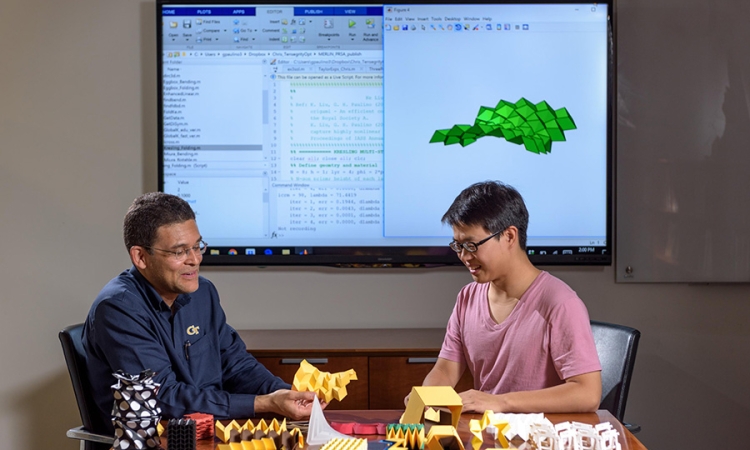 Researchers Glaucio Paulino (left) and Ke Liu with origami structures that can be simulated in new software. (Photo: Rob Felt)