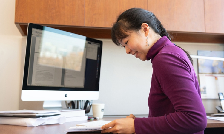 Assistant Professer Iris Tien sits at her desk in her Georgia Tech office. (Photo: Allison Carter)
