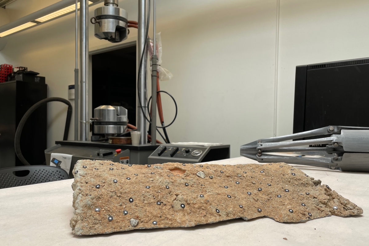 A rockon a table in front of metal equipment 