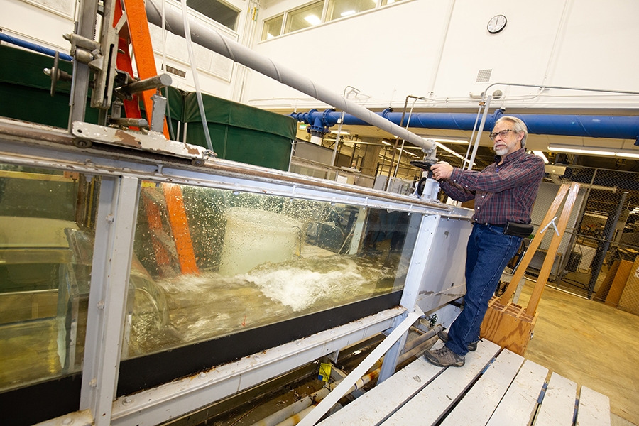 A man operates a flume filling with water