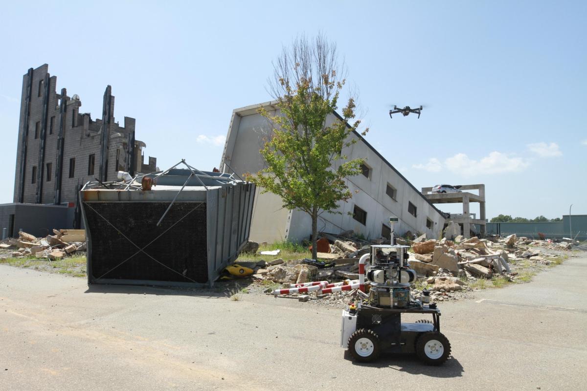 A rover and drone on a simulated construction site