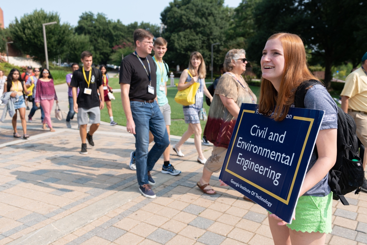 Person holding sign that reads Civil and Environmental Engineering