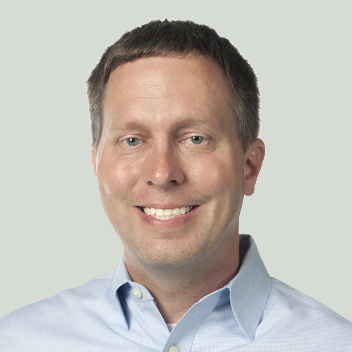 Portrait of Eric Marks in a light blue oxford shirt