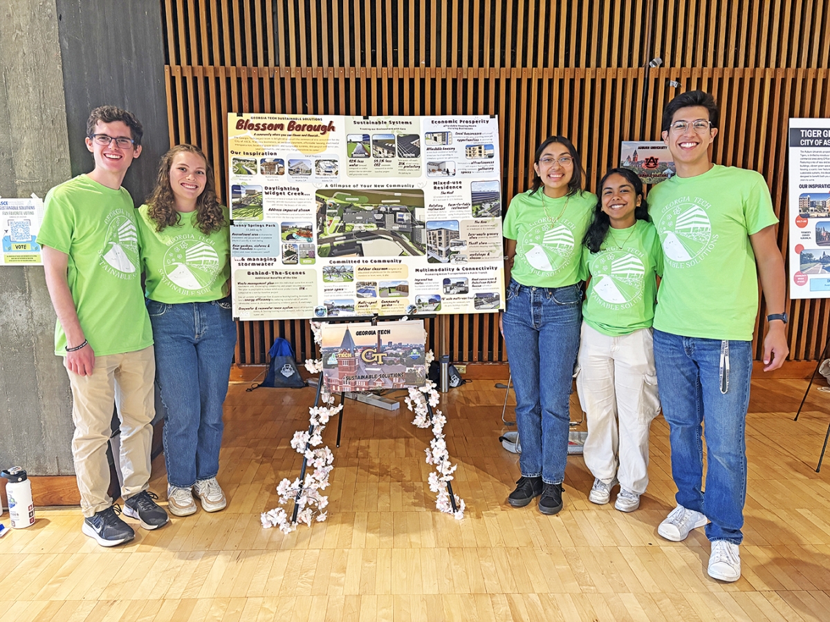 Five students posing around a Poster describing their Blossom Borough Project
