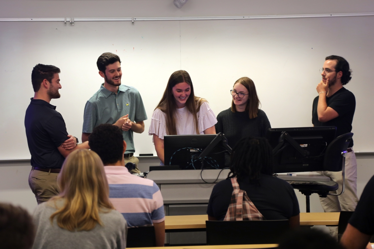 A group of students giving a presentation in a classroom