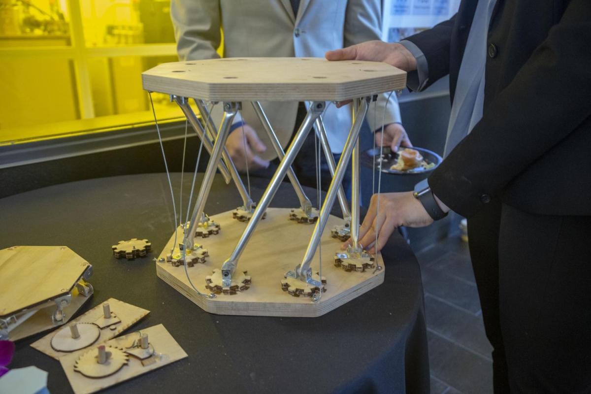 Students demonstrating a model of a device in an entrepreneurial setting.