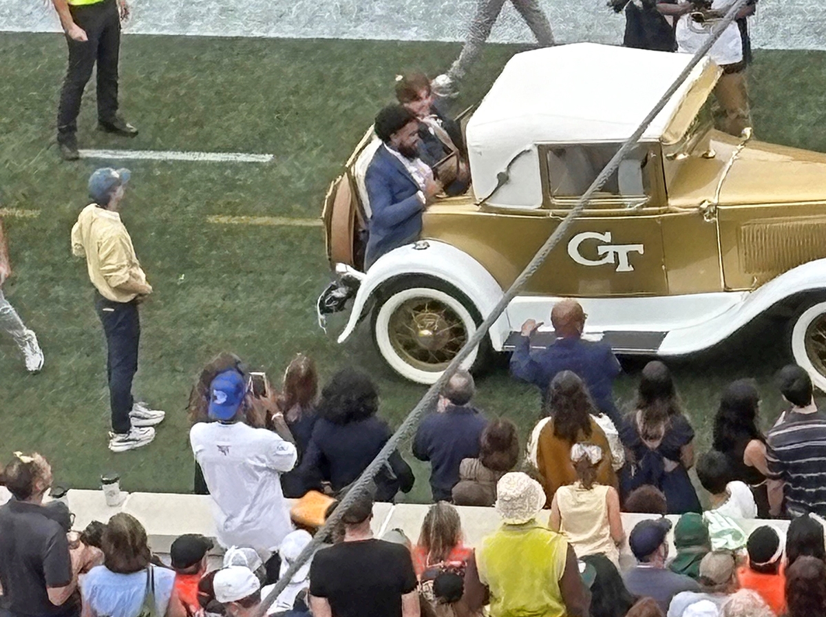 Environmental engineering fourth-year student Harrison Baro rides in the rumble seat of the Ramblin’ Reck with fellow honoree Caleb Buchanan