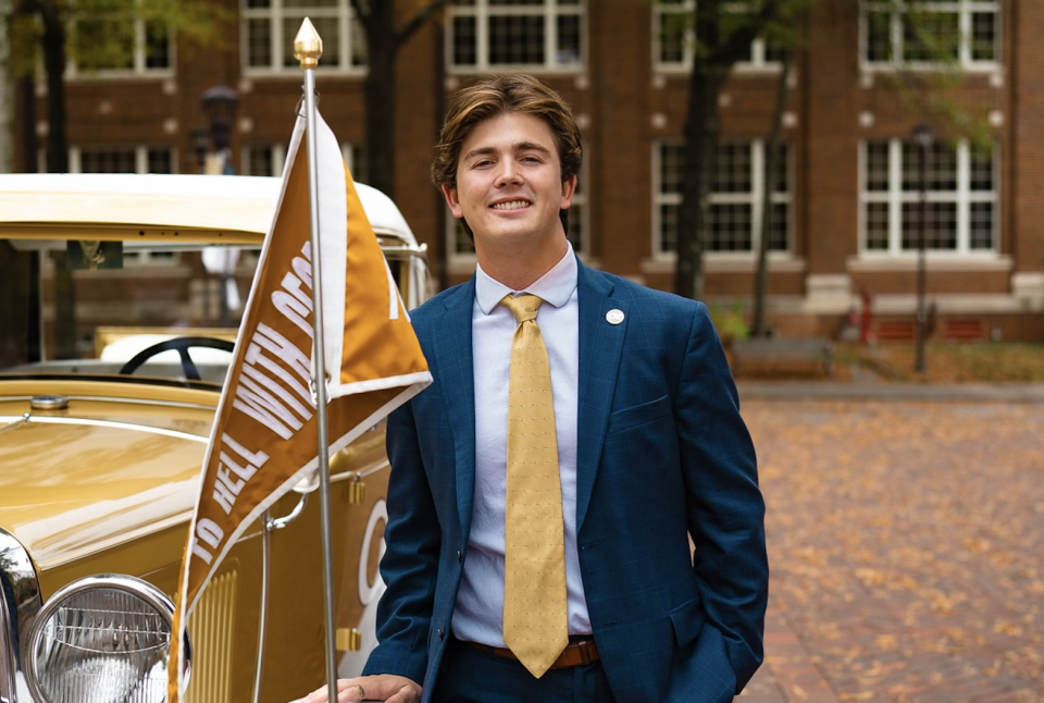 Harrison Baro stands next to the Ramblin' Wreck at Georgia Tech 