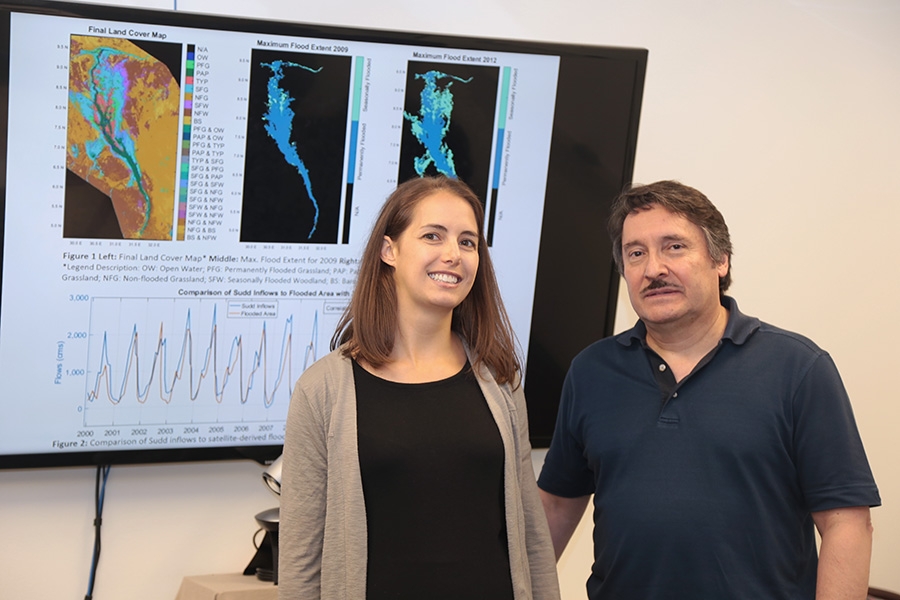Courtney Di Vittorio, left, with her Ph.D. adviser, Aris Georgakakos and some of the data she's using for her research. Di Vittorio's work to incorporate satellite data into hydrologic models so decision-makers can improve water management plans has won her a 2017 Earth and Space Science Fellowship from NASA. (Photo: Jess Hunt-Ralston)