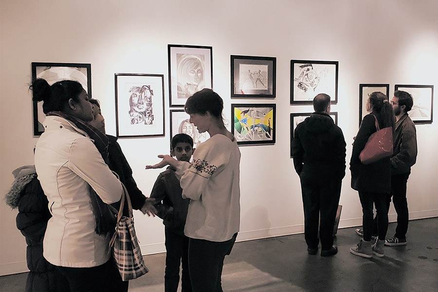 Visitors consider the artwork created by students in Francesco Fedele's Visual Arts and Geometry course at the Kai Lin Gallery Dec. 11. The drawings hung for one night at the gallery to celebrate the students' work in the class, which connected advanced geometry with art through the lenses of Einstein and Picasso.