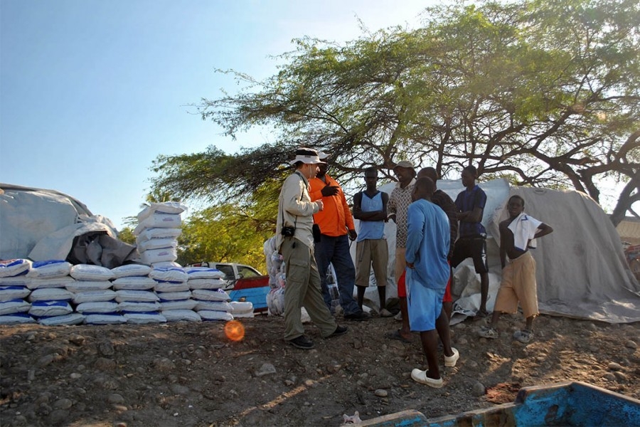 Hermann Fritz, right, talks with people in Haiti on one of his research trips after an earthquake wreaked havoc on the island nation in 2010. Fritz told public radio's Marketplace the temporary communities that have since sprung up on the country's hillsides are now at risk from flooding and landslides in the wake of Hurricane Matthew. (Photo: Jean Vilmond Hilaire, Université de Quisqueya)