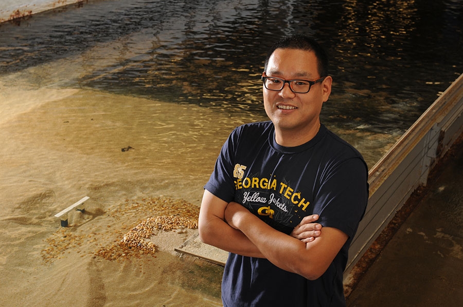 Seung Ho Hong in the Donovan Hydraulics Laboratory with the flume used in his study.