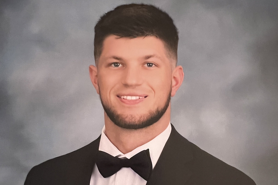 A smiling man wearing a tuxedo