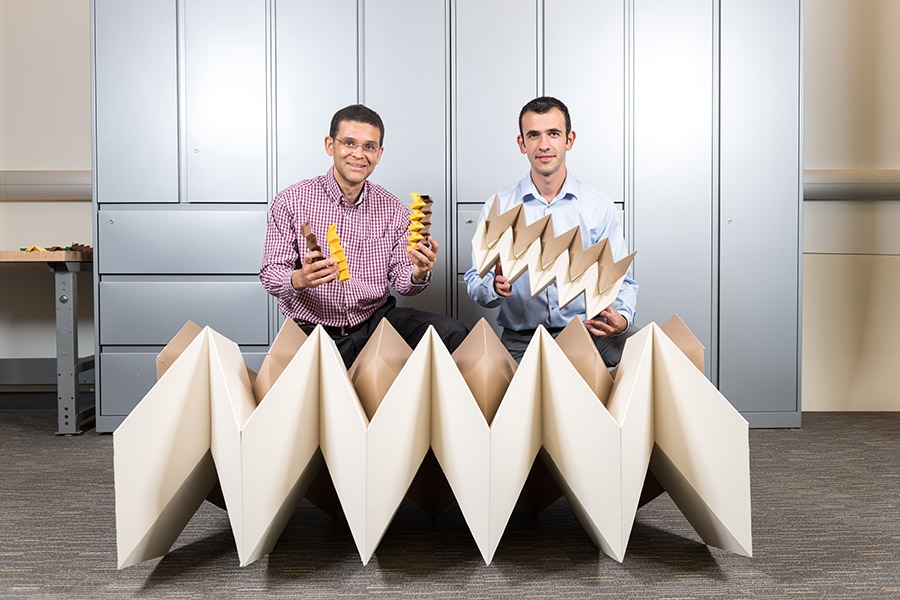 Glaucio Paulino and Evgueni Filipov with models of their zippered tube origami configuration. (Photo: Rob Felt)