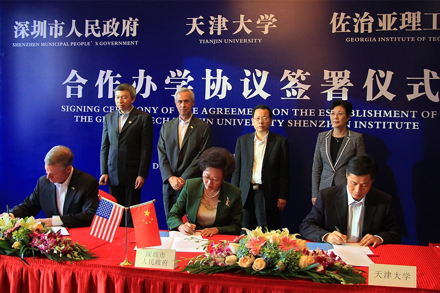 Georgia Tech President G.P. “Bud” Peterson, seated left, signed an agreement in a ceremony in Shenzhen, China, Dec. 2 to create a new collaboration with the City of Shenzhen and Tianjin University. Co-signers with Peterson are Vice Mayor Yihuan Wu of Shenzhen Municipal People's Government, center, and Tianjin University President Denghua Zhong, right.