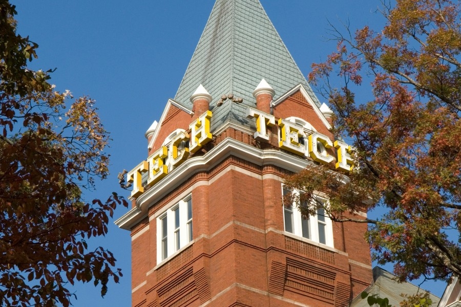 Tech Tower against a blue sky surrounded by trees