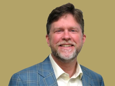 Portrait of Taylor Wright in a blue blazer and white shirt