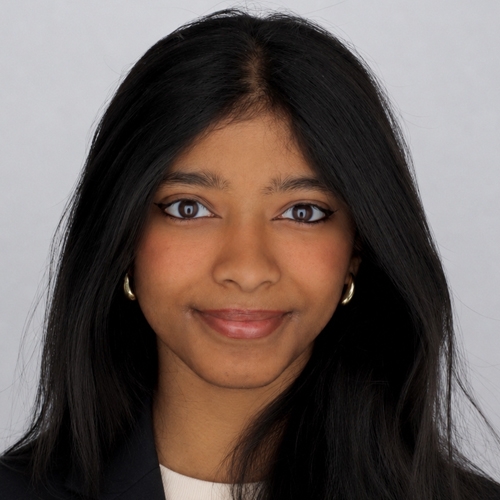Portrait of Prathyusha Paresh wearing a white t-shirt and a black blazer