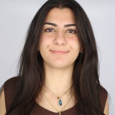 Portrait of Bahar Banihashemi in a brown top with two necklaces
